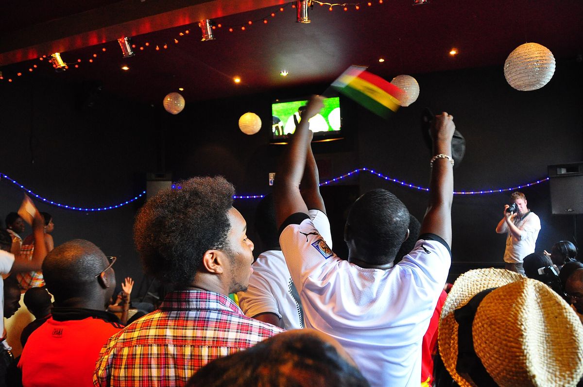Ghana national football team (also known as the Black Stars ) fans watching the Ghana national football team play Uruguay national football team on television at 2010 FIFA World Cu