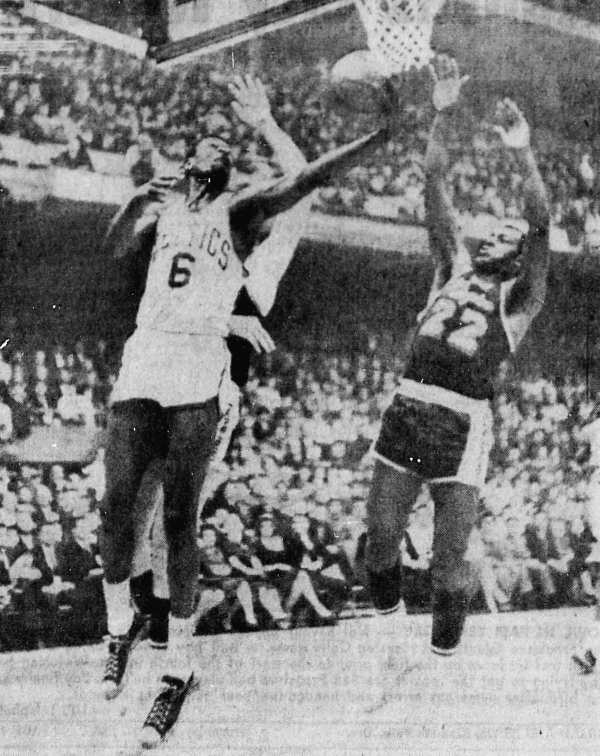 Boston Celtics center Bill Russell (left, number 6) attempts a layup as Los Angeles Lakers forward Elgin Baylor defends (right, number 22) during the second game of the 1963 NBA Fi