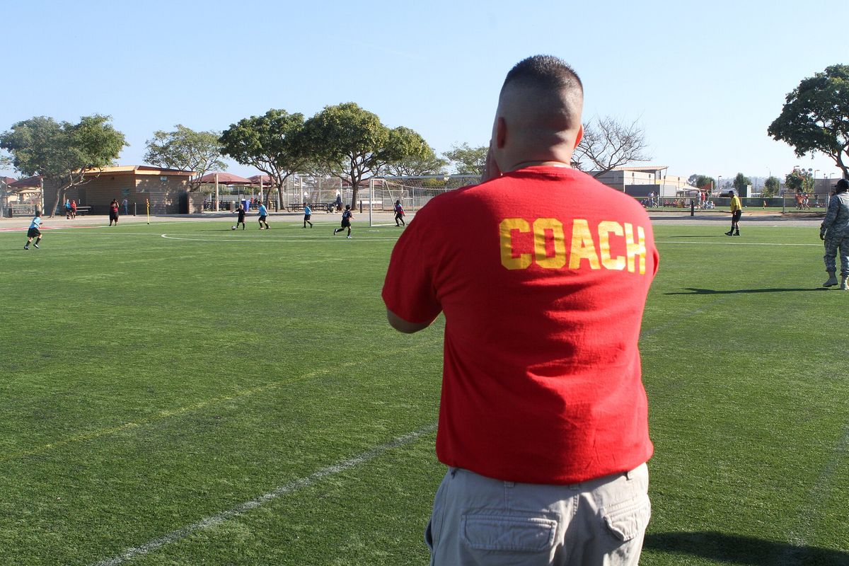 Capt. Justin Taricani, a coach with the Flying Eagles soccer team and a New Britain, Conn., native, calls instructions to his team during a game at the Youth Sports Complex aboard 